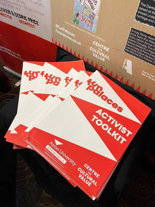 A fanned stack of Fun Palaces' activist toolkits at a conference exhibition stall.