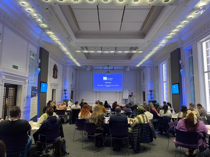Attendees seated at a workshop at The RCN's Student Ambassador Conference at its headquarters in central London as its Chief Executive and General Secretary Nicola Ranger gives the event's opening speech.
