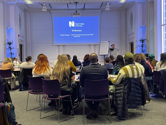 Attendees seated at a workshop at The RCN's Student Ambassador Conference at its headquarters in central London as its Chief Executive and General Secretary Nicola Ranger gives the event's opening speech.
