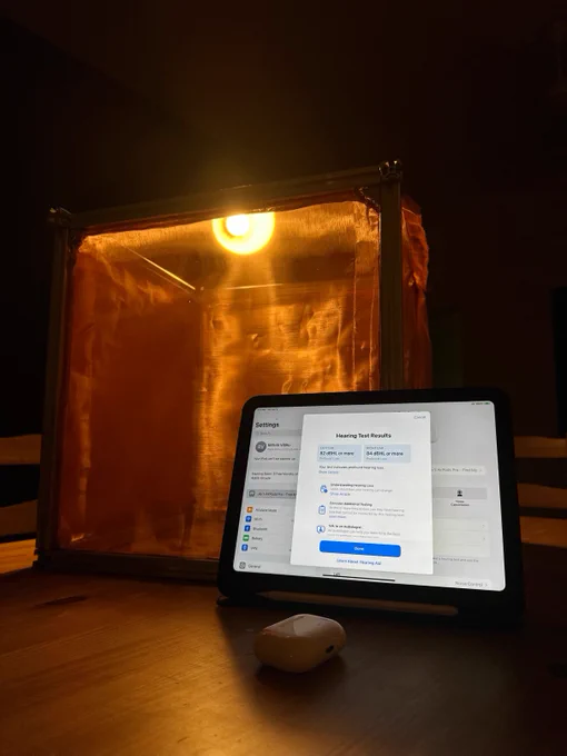 An Airpods case, an iPad, and a Faraday cage made of copper and aluminum