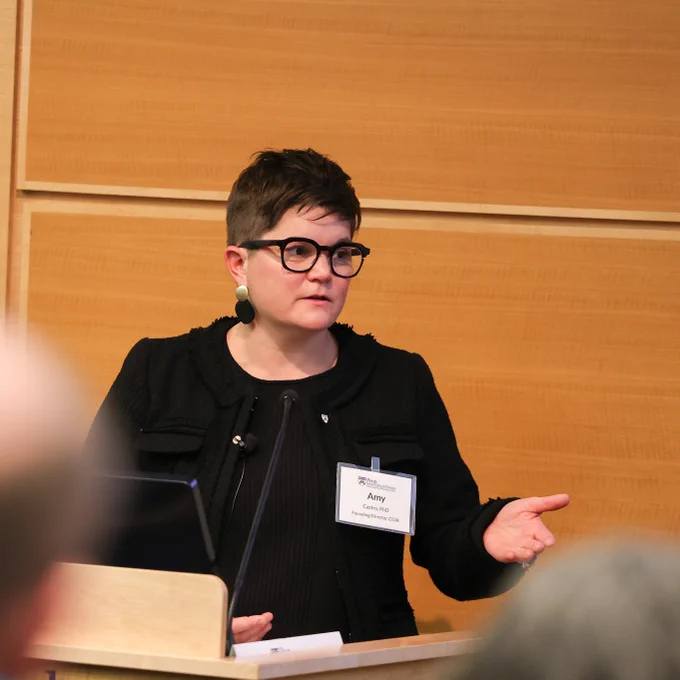 Amy Castro speaks at a podium.