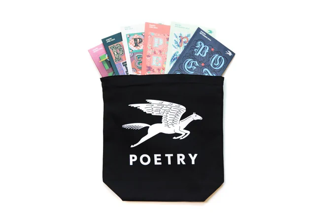 A black tote bag with a white pegasus above the word Poetry; the bag has several copies of Poetry magazine peeking out of it.