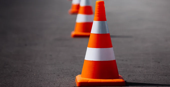 Photo of a traffic cone on a road.