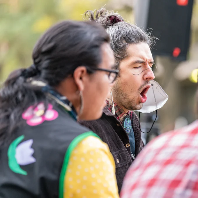 Two people outdoors singing