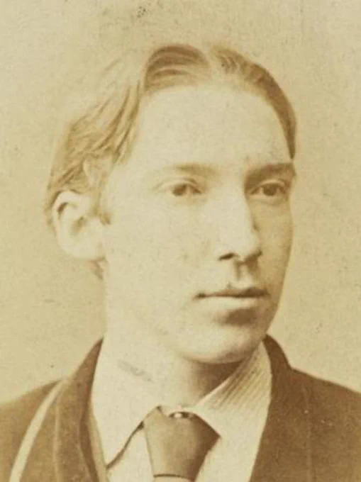 Vintage sepia-toned photograph of a young Robert Louis Stevenson in formal attire.