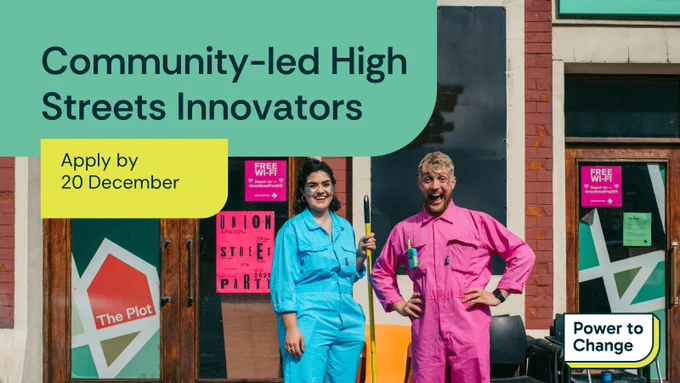 Text: Community-led High Streets Innovators. Apply by 20 December. 

Image: Two people in bright coloured jumpsuits holding brooms and standing outside of a colourfully boarded building, The Plot, on Union Street.