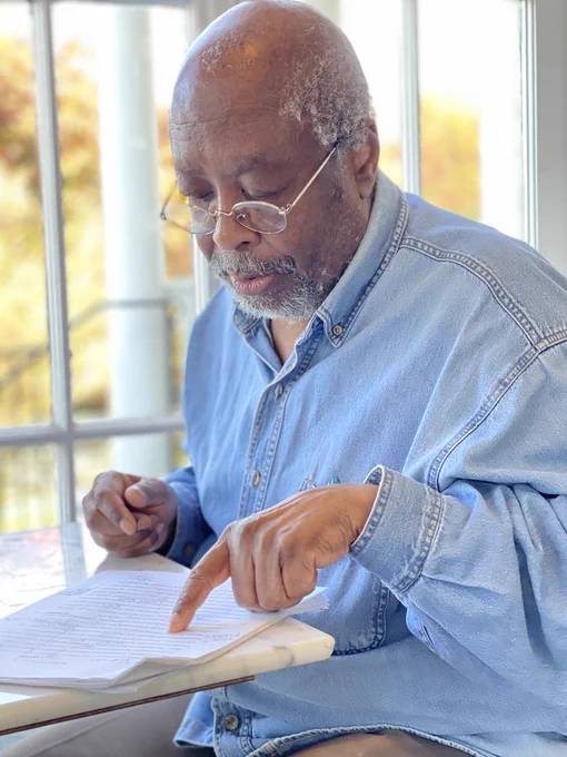 Photo of author Edward P. Jones discussing the work of a 2024 Kweli fellow. 