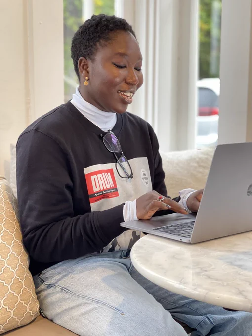 Photo of a 2024 Kweli fellow going over their work with author Edward P. Jones. 