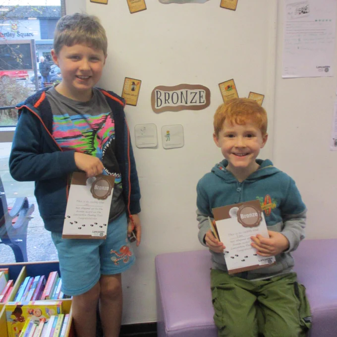 two boys with certificates
