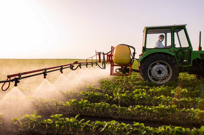 A tractor spreading traditional fertiliser