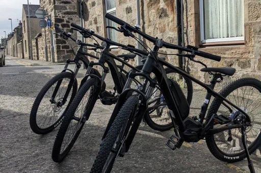 Photograph courtesy of NESTRANS.
Three E-Bikes parked in Huntly.