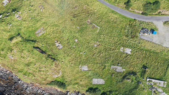 Aerial view of the Rodel Park accommodation block (SCAPE ID 16450). The concrete hard standing for five Nissen huts are visible, as well as the air shaft for the air raid shelter in the bottom right. Ken Watson, who served at Rodel Park, recalled his arrival at his Nissen hut accommodation and its remarkable position: the highest and closest to the sea. Another of the Nissen huts accommodated the Canadian personnel and was named ‘Canada House’.