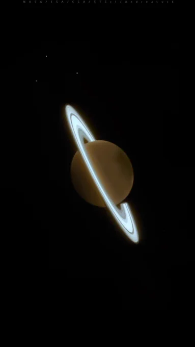 Image of Saturn and some of its moons, captured by the James Webb Space Telescope’s NIRCam instrument on June 25, 2023. The planet is a dark orange while the rings are a bright, pale blue. The planet is tilted from upper left to lower right, with the three moons at the top.