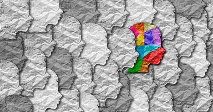 Abstract image of several gray silhouettes with one colorful one. 