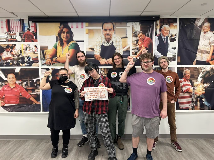 Bargaining unit members holding a sign in solidarity with Viscofan workers