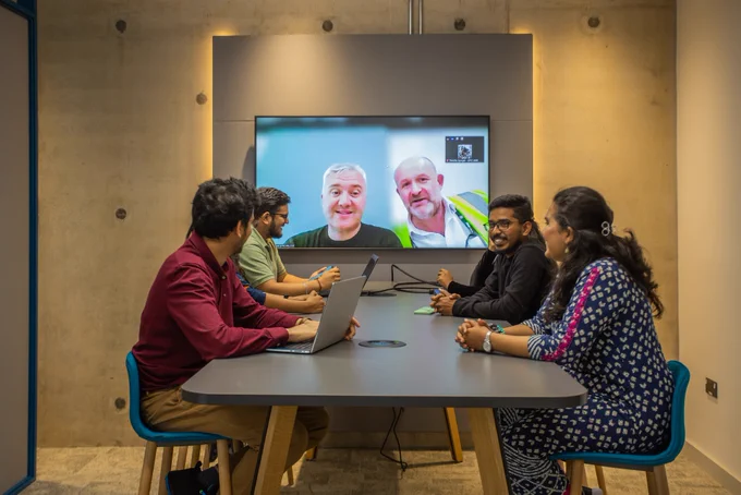 Group of Engineers and technicians hold a hybrid zoom meeting in one of EPAC's new meeting rooms