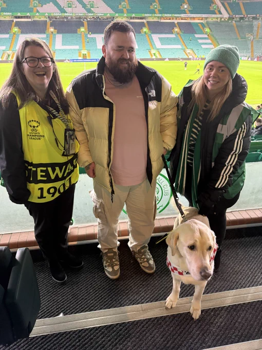 Jon and Sam stand with Nicola and Katie from the disability support team at Celtic in the directors box