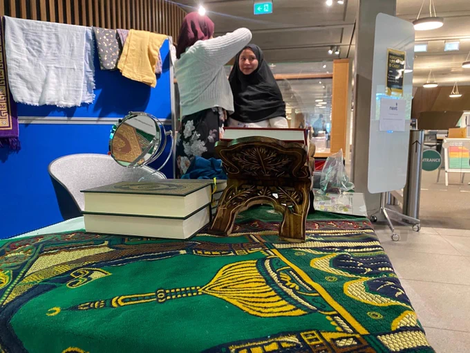 Image shows a student trying on a hijab