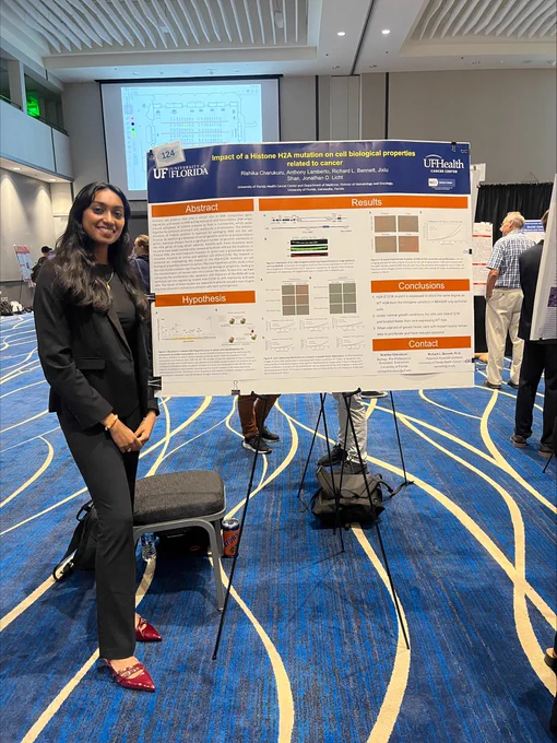 A student presents her poster during the research symposium.
