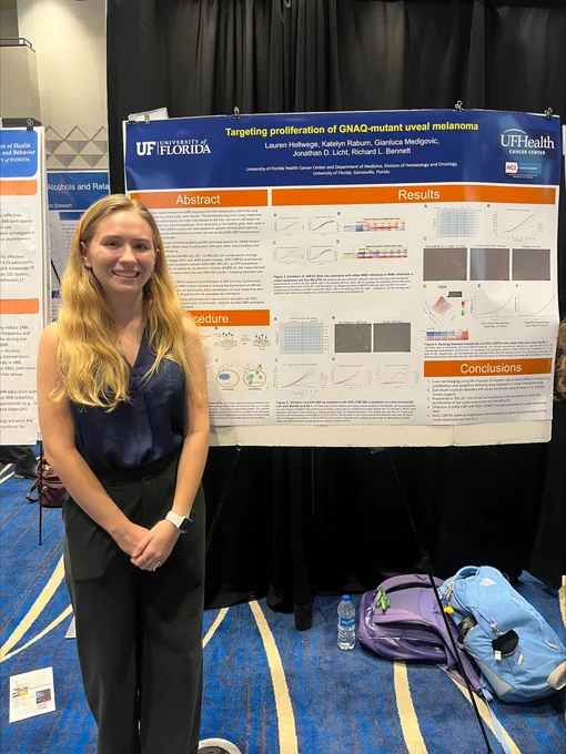 A student presents her poster during the research symposium.