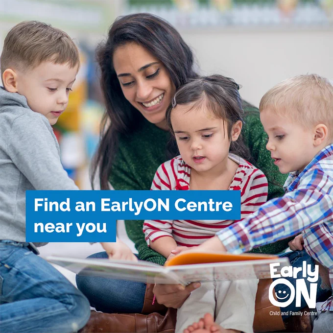 A group of young children doing reading a picture book with a child care worker. Text reads: Find an EarlyON Centre near you