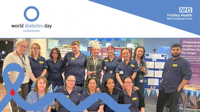Group of healthcare professionals gathered around an information stand decorated with banners for World Diabetes Day at Frimley Health NHS Foundation Trust.