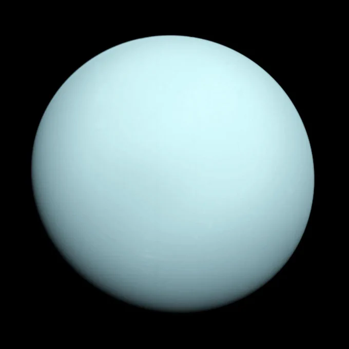 An image of the planet Uranus, as seen by NASA's Voyager 2 spacecraft. The gas giant appears here as a smooth, virtually featureless, light blue ball, with the very bottom in slight shadow. The background is completely dark. Credit: NASA/JPL-Caltech