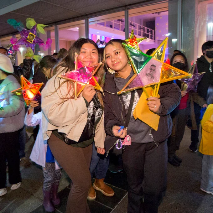 Two people holding colorful parol lanterns at the Parol Lantern Festival at Yerba Buena Center for the Arts.
