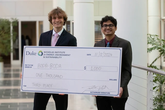 A team of graduate students from McGill University holds an oversized check for $1,000 for winning third place in the 2024 Energy in Emerging Markets Case Competition.