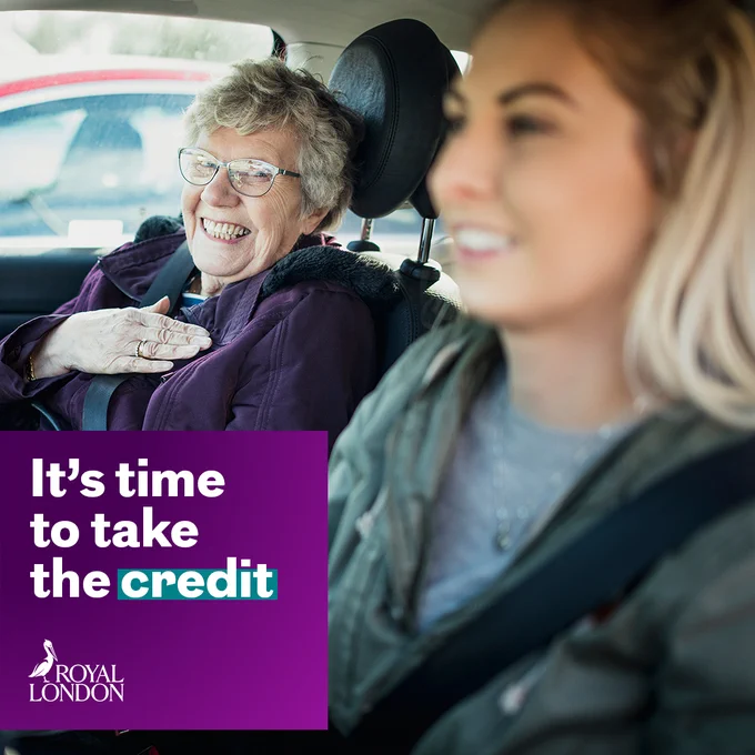 A younger and older person sat in a car with their seatbelts on 

White text with purple background says: It's time to take the credit