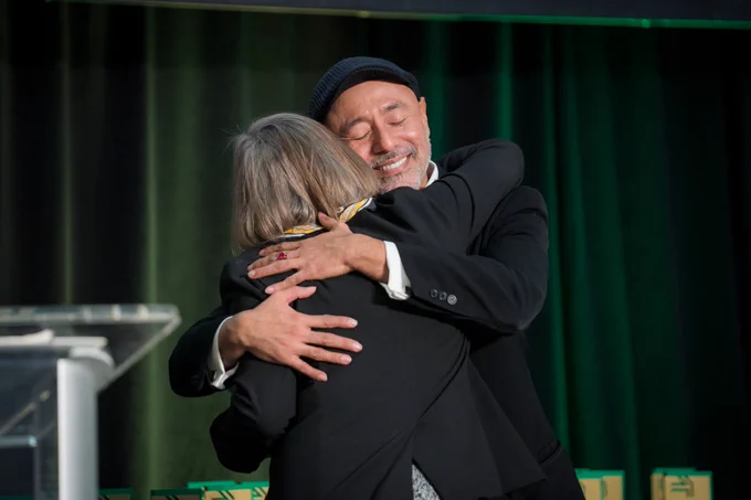 Dean Ardis hugs Community and Catalyst recipient, Juan Pacheco.
