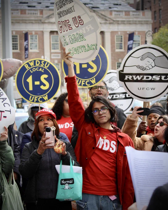 union supporters hold signs at a rally