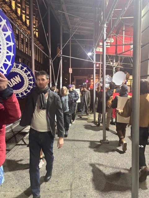 UAW and RWDSU members picketing outside The Strand together holding signs