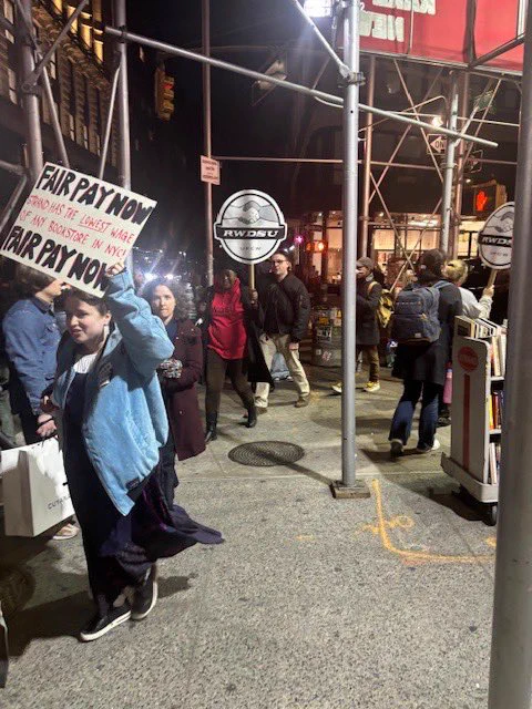 UAW and RWDSU members picketing outside The Strand together holding signs