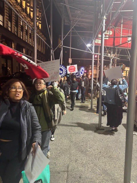 UAW and RWDSU members picketing outside The Strand together holding signs