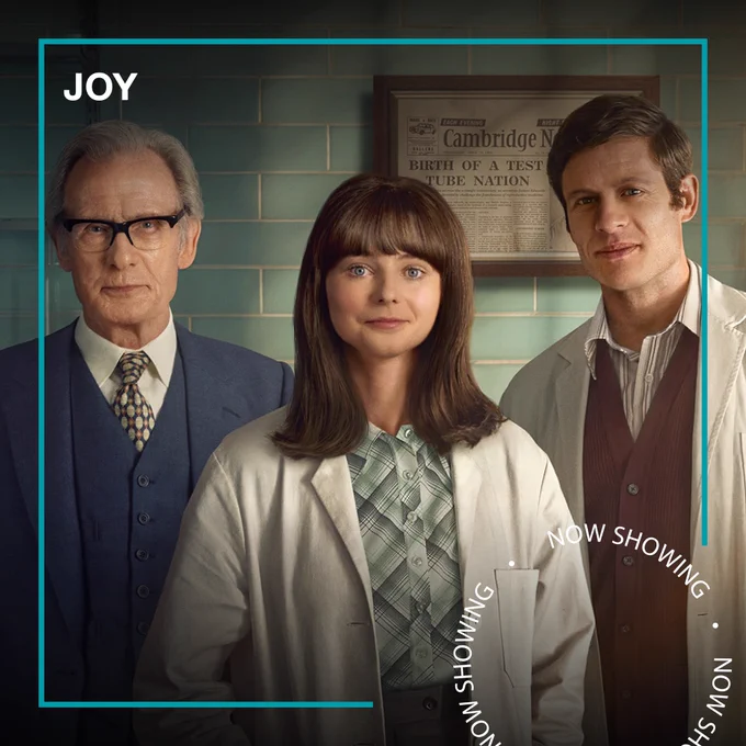 Three scientists – two men and a woman – stand and pose for a photo in Joy. Text - Joy, Now Showing