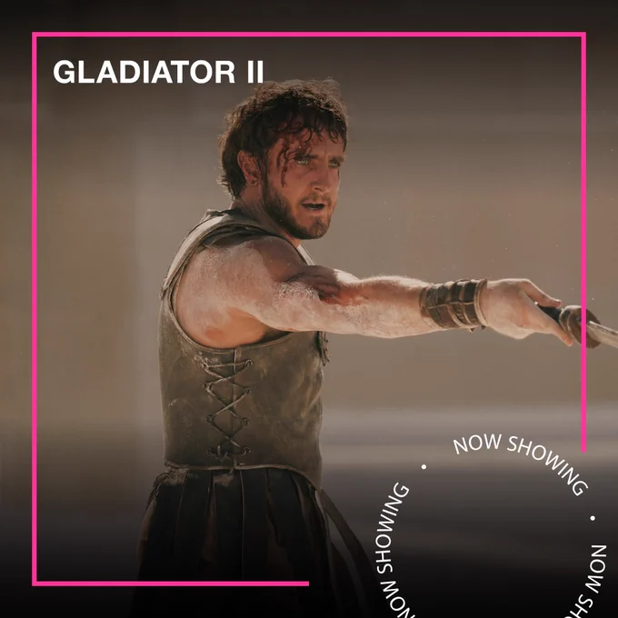 Paul Mescal holds a sword in Gladiator II, his head injured. Text - Gladiator II, Now Showing