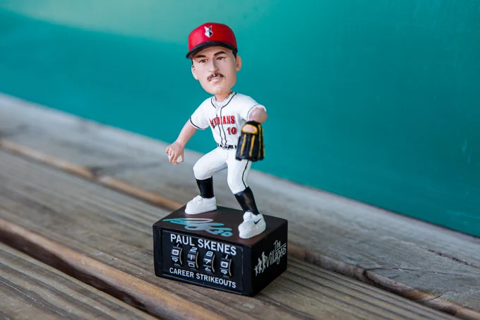 A photo of an autographed Paul Skenes bobblehead in the home dugout at Victory Field. 