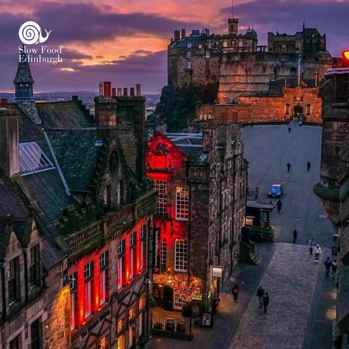 Picture of Contini's Cannonball Restaurant building, with Edinburgh Castle as the backdrop, featuring the Slow Food Edinburgh snail logo in the top left corner.