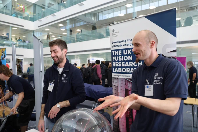 Two diamond scientists talking at a careers fair 
