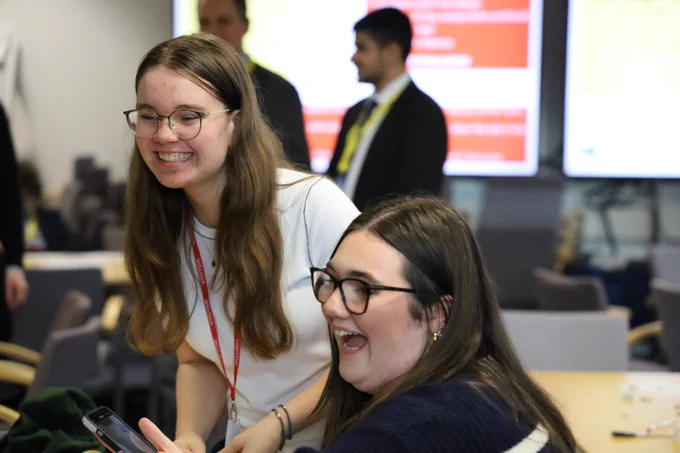 Two female students laughing 