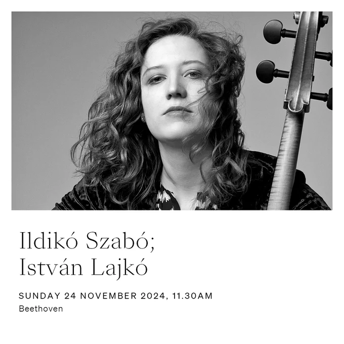 Ildikó Szabó; István Lajkó. Sunday 24 November 2024, 11.30am. Cellist Ildikó Szabó poses in a black suit and patterned shirt with a cello. The image is black and white.