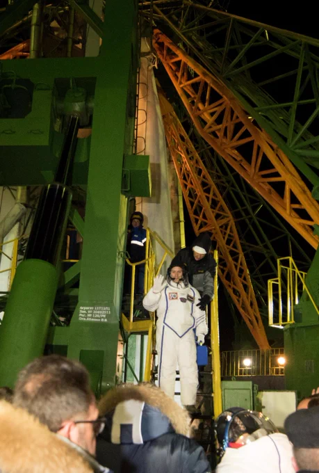 ESA Astronaut Thomas Pesquet is standing on the steps at the base of the launch tower, waving to well-wishers before he boards the rocket that will take him to the International Space Station.