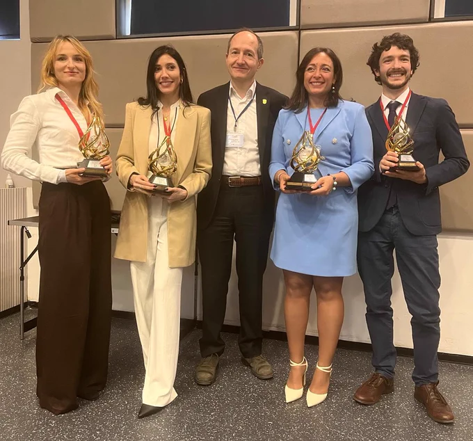 Dr Andrea Luppi (right) holds his prize trophy alongside fellow scientists at the 9th International Congress of the Universal Scientific Education and Research Network and Prize Awarding Festival in Bulgaria.