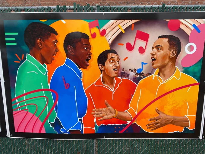 A colorful painting of four Black men singing, with open-collar dress shirts of vibrant green, blue, red, and orange. An orchestra in a band shell is visible in the background with colorful musical notes floating above.