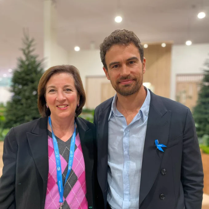 PRM Acting Assistant Secretary Marta Youth stands with UNHCR Goodwill Ambassador Theo James.
