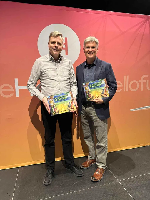 Dr. Leemon Baird, inventor of Hashgraph and Mance founders of Hedera, with The Adventures of King Shibar Book in hands.
