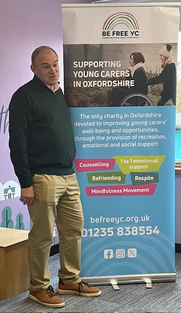 Sir Ed Davey standing by Be Free YC banner