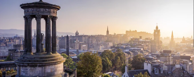 Edingburgh skyline from Calton Hill Dugald Stewart monument to left wiht sicty vista lit by sun
