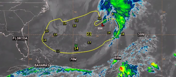 GOES-16 IR image from 1800 UTC showing location of 994 mb low pressure center across the W Atlantic and cold front extending SW and into northern Cuba. Yellow contour identifies area of seas 12 ft and greater, with wave height observations in yellow numerals.